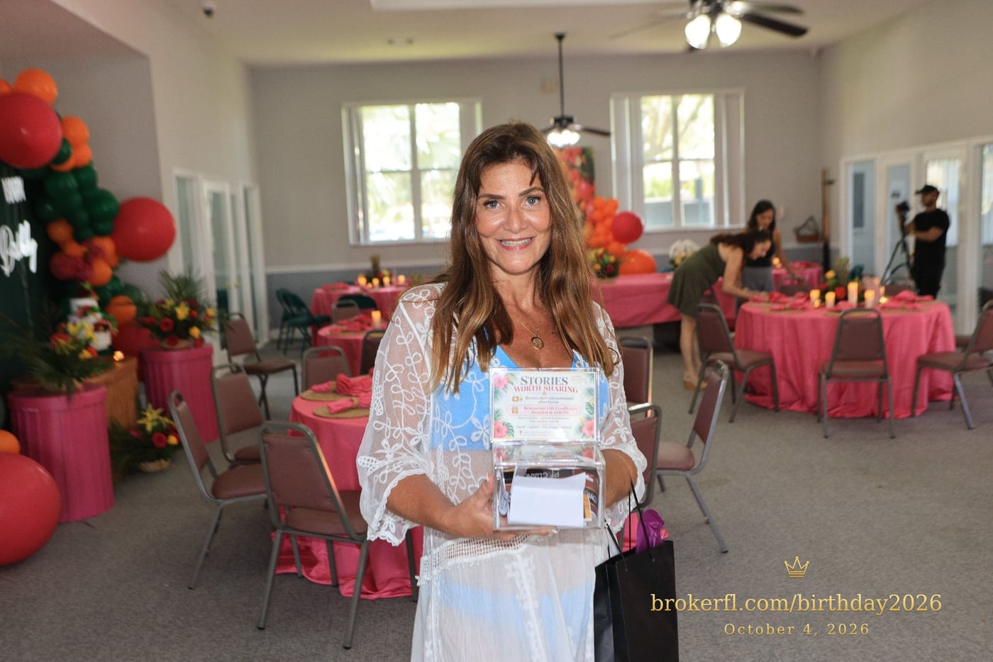 Guest in a white lace cover-up inside the decorated party room — Karina Leal's birthday, October 4, 2026.