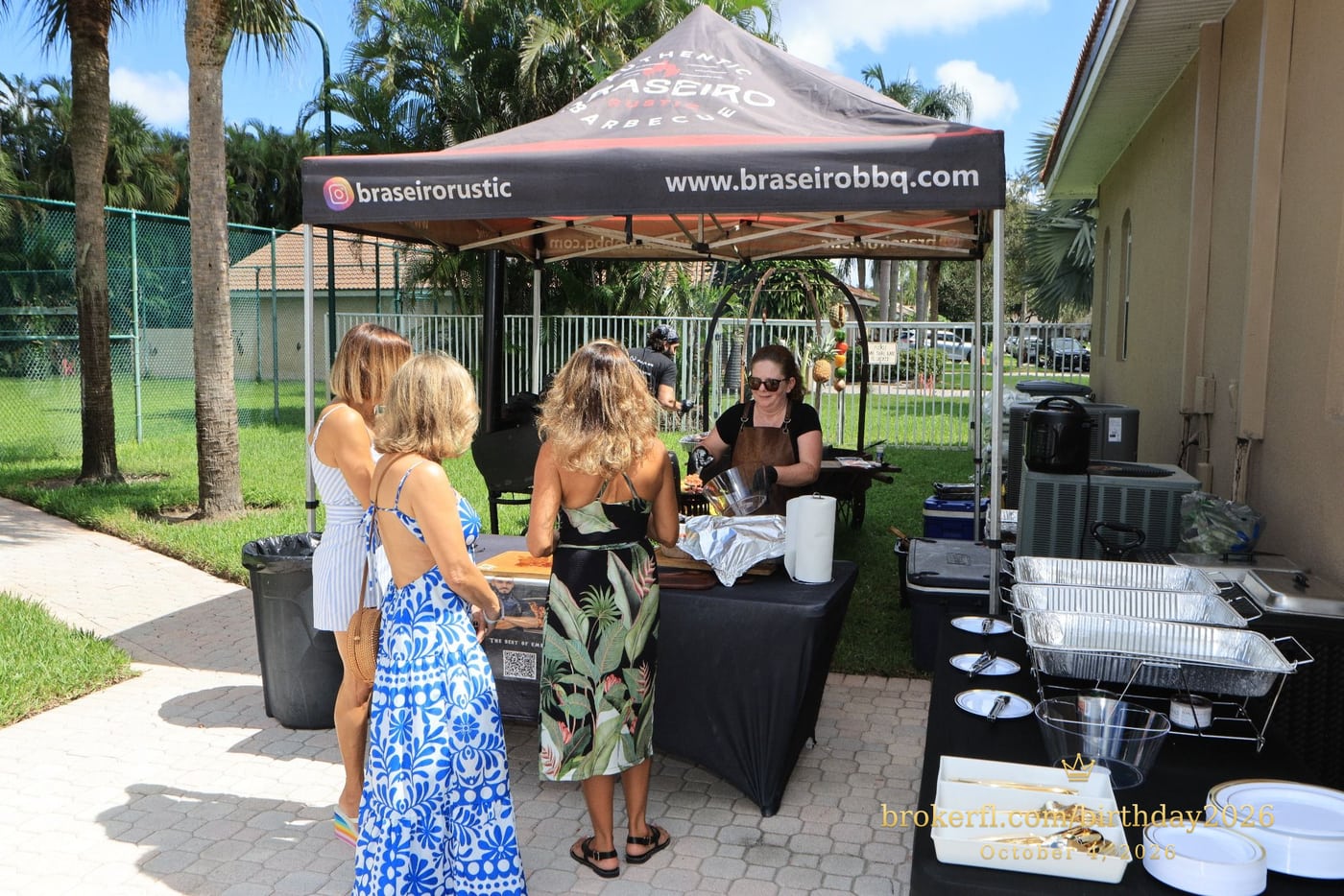 Guests talking beside the outdoor barbecue station — Karina Leal's birthday, October 4, 2026.