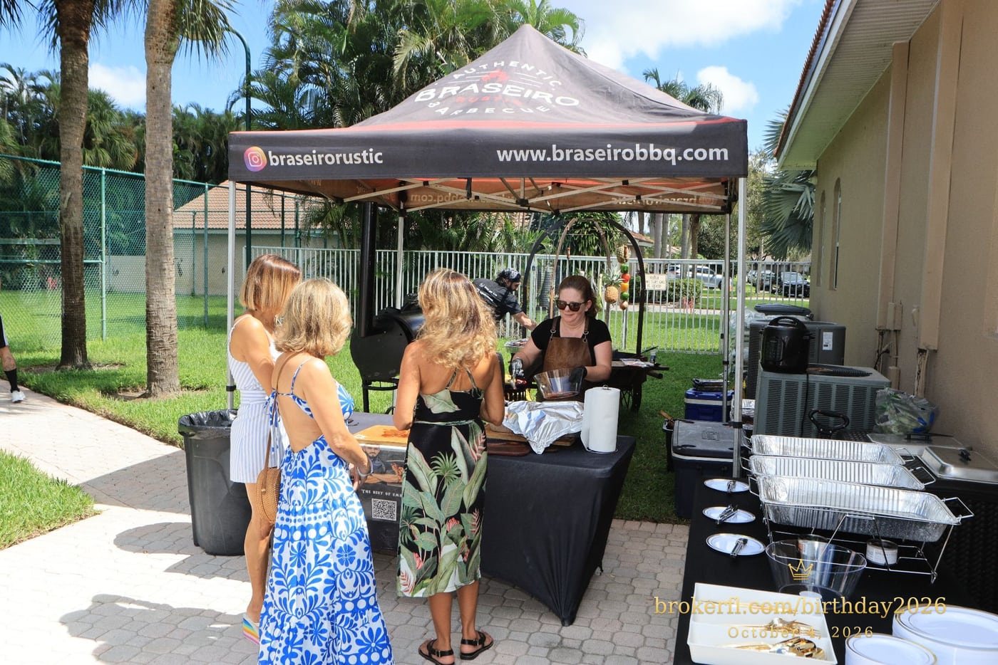 Guests talking beside the outdoor barbecue station — Karina Leal's birthday, October 4, 2026.