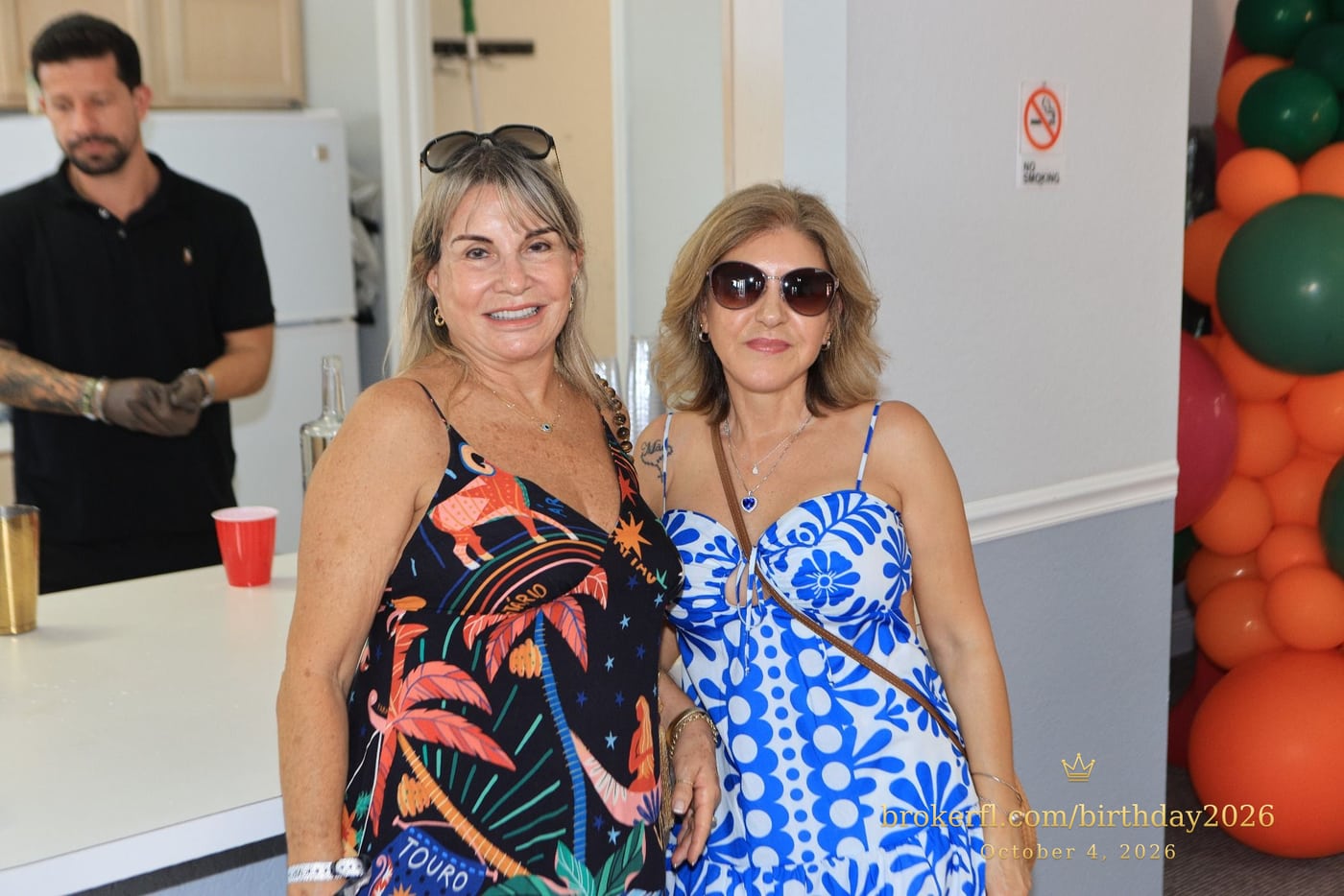 Two guests wearing tropical patterned dresses — Karina Leal's birthday, October 4, 2026.