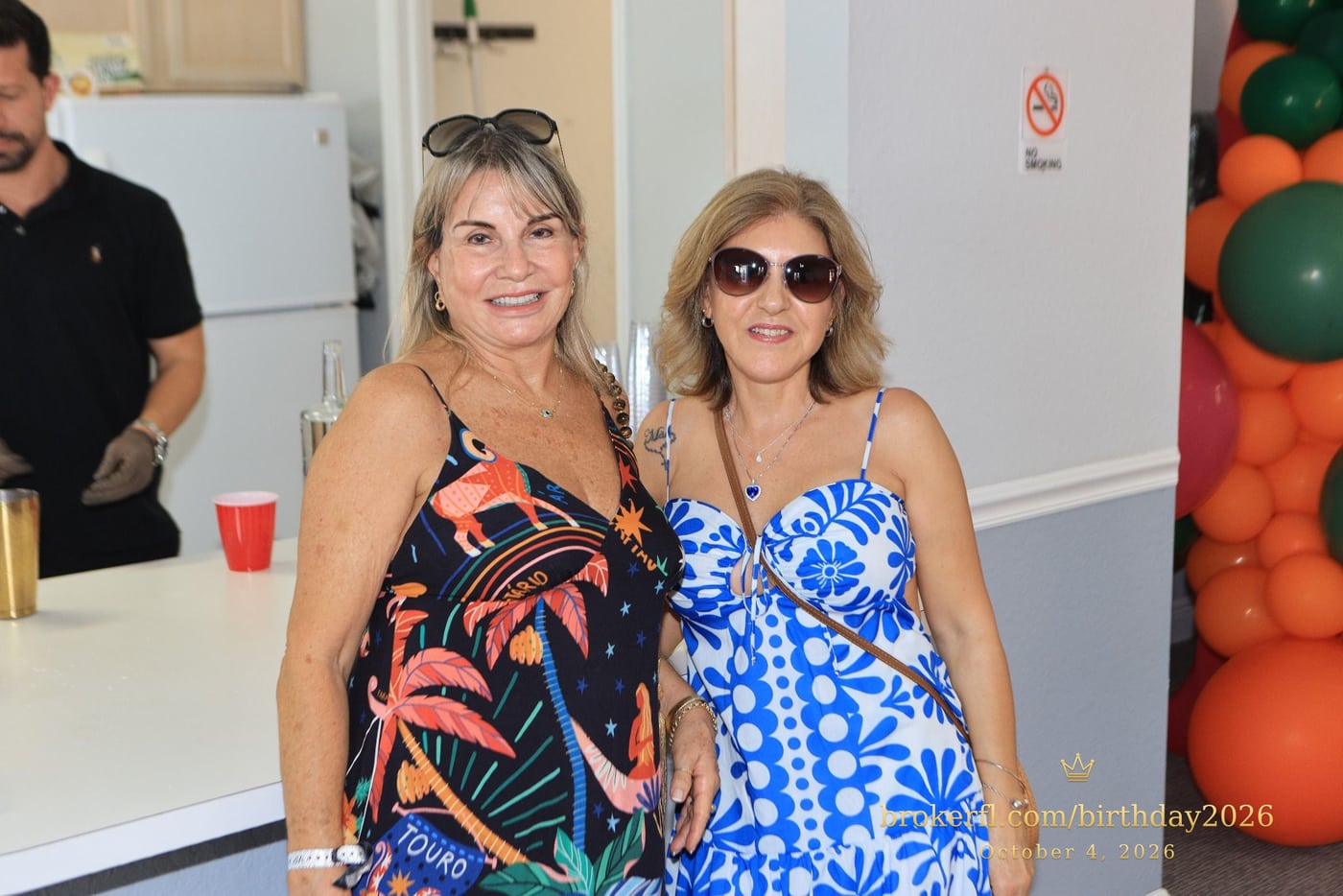 Two guests wearing tropical patterned dresses — Karina Leal's birthday, October 4, 2026.