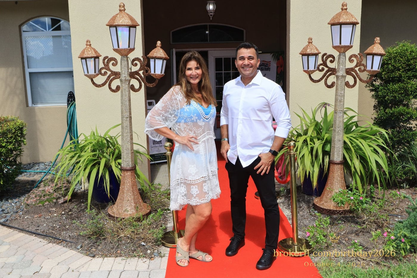 Two guests posing on the red carpet outside the venue — Karina Leal's birthday, October 4, 2026.