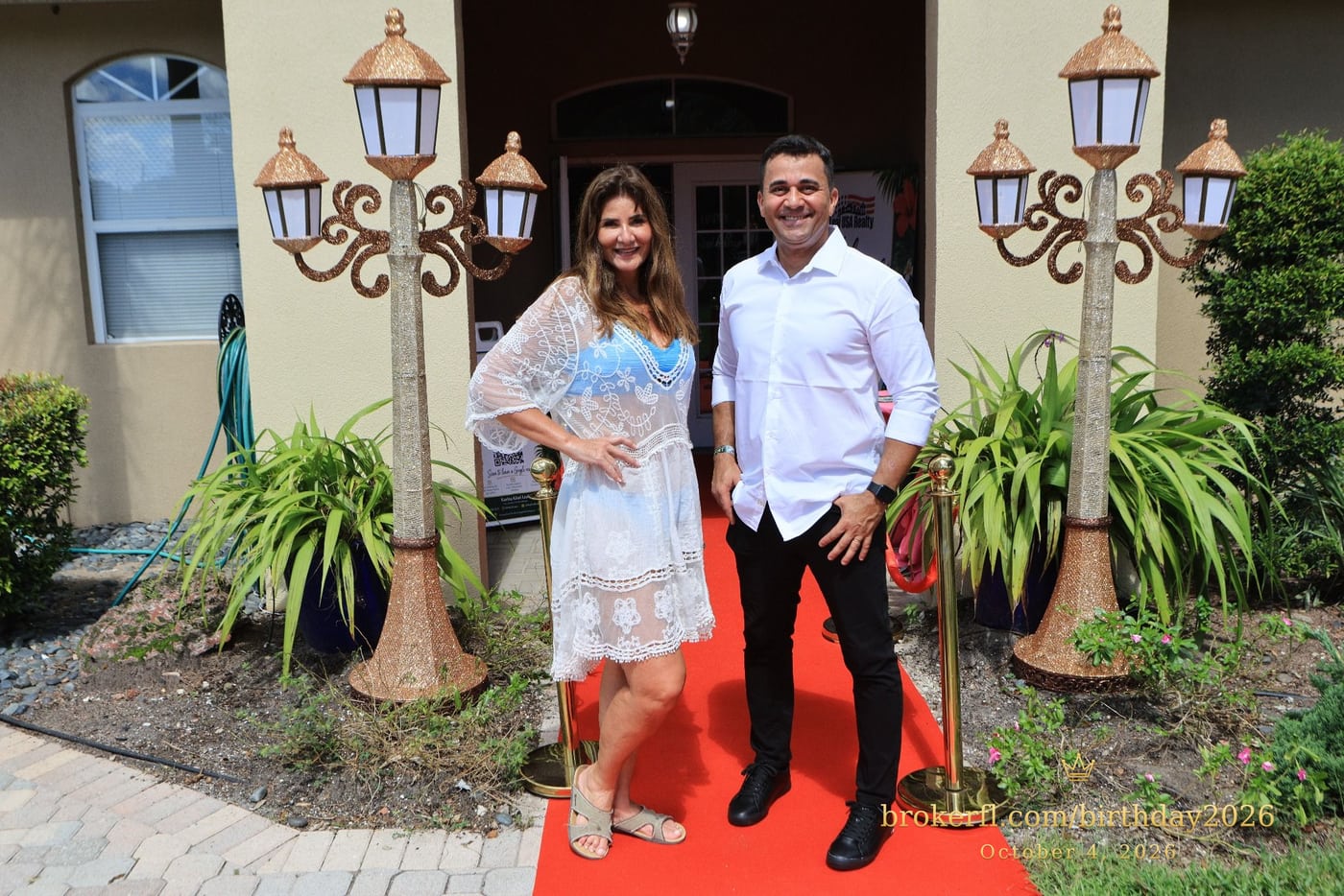 Two guests posing on the red carpet outside the venue — Karina Leal's birthday, October 4, 2026.