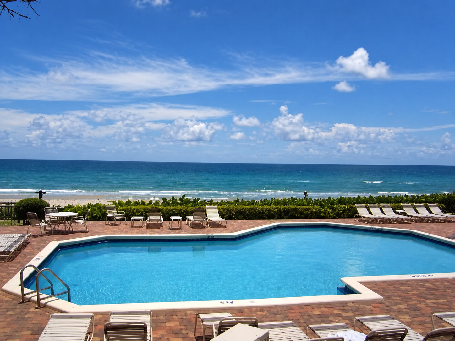 Community pool and oceanfront setting at Townhouses of Highland Beach